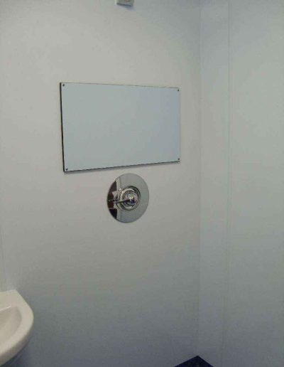 A mirror in a white bathroom